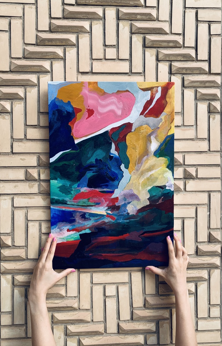 Painting held against a tiled wall
